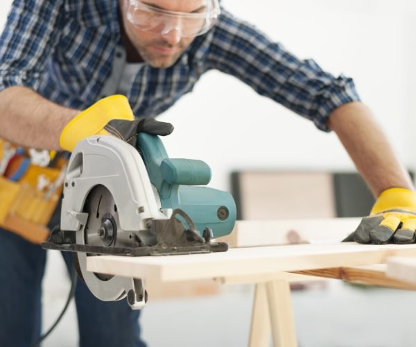 Carpenter working with circular saw